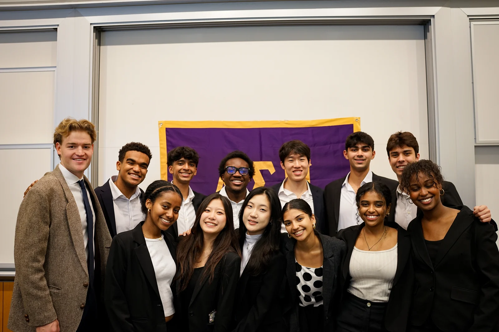 Members of the Beta Nu chapter gathered in front of the Delta Sigma Pi flag